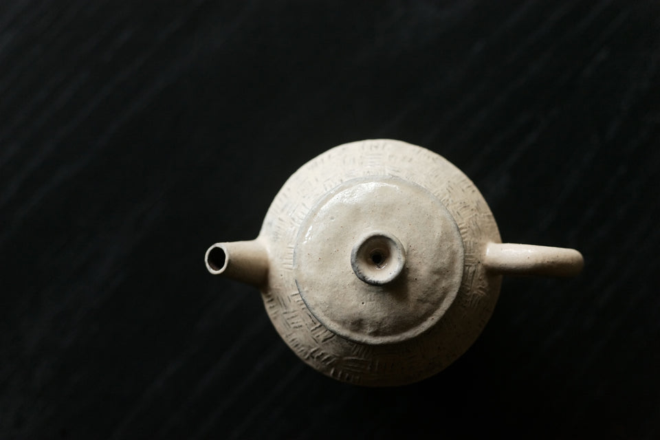 Hand-made white powder-glazed teapot with geometric patterns